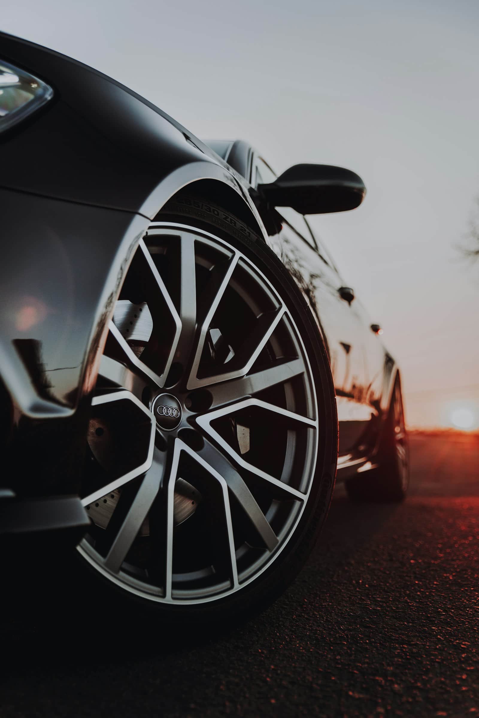 Low-angle close-up of a detailed alloy wheel and brake package