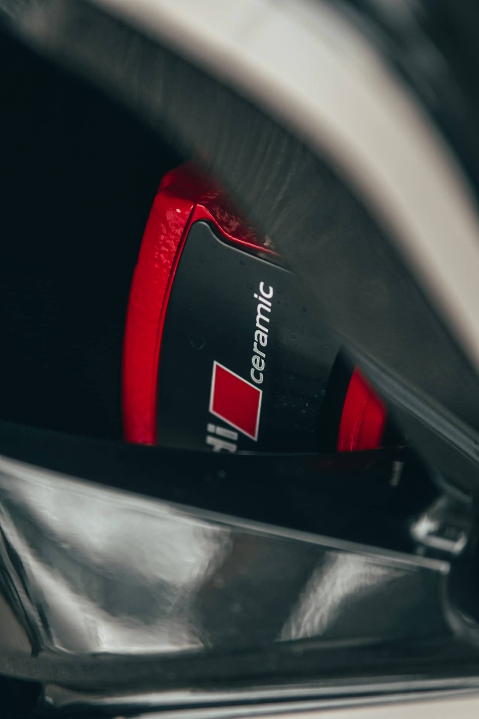 Detailed ceramic brake caliper behind a cleaned wheel face